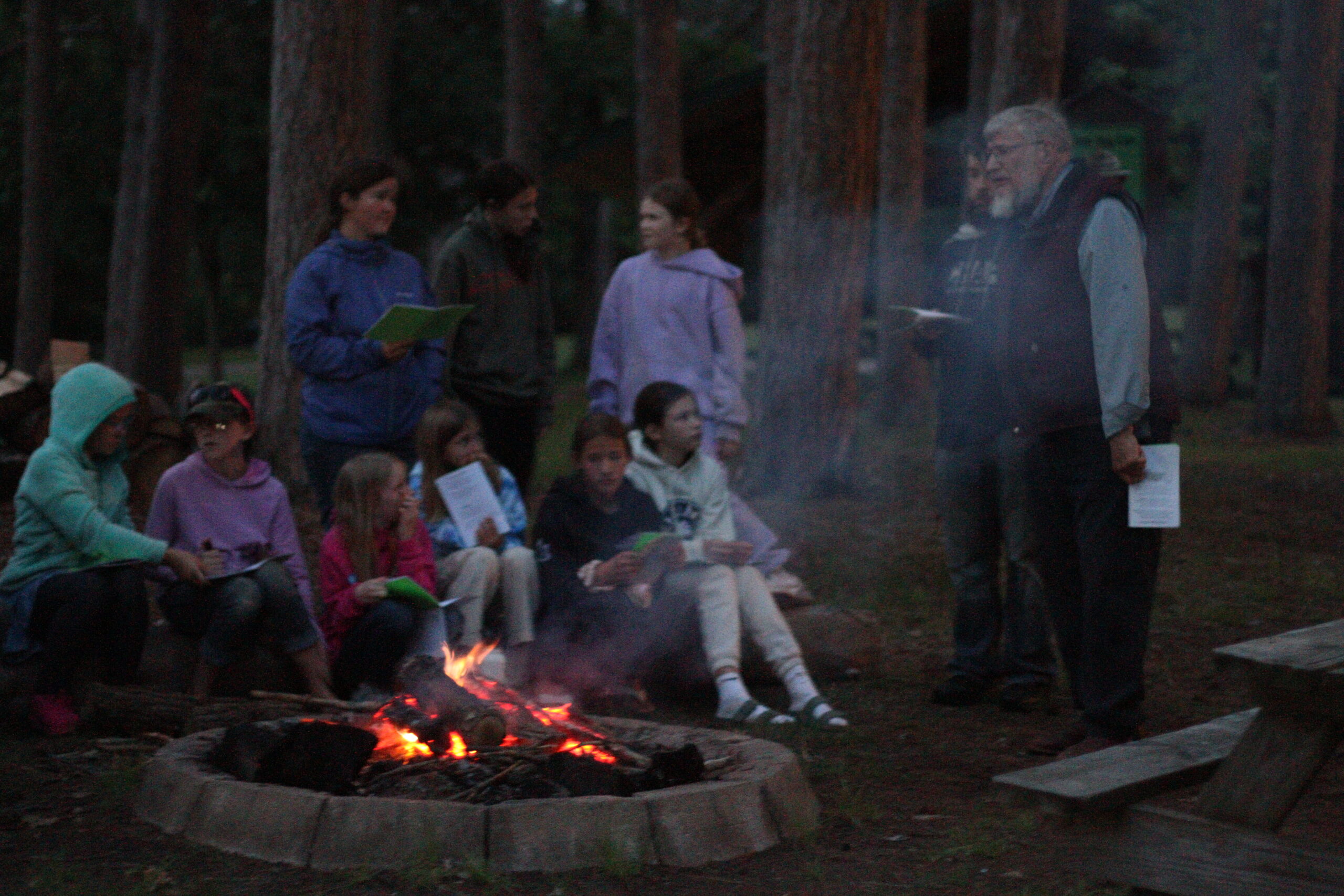 Evening campfire with sparks and happy campers